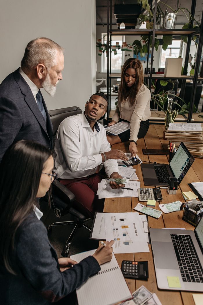 A diverse group of professionals engaging in a collaborative effort in the office.